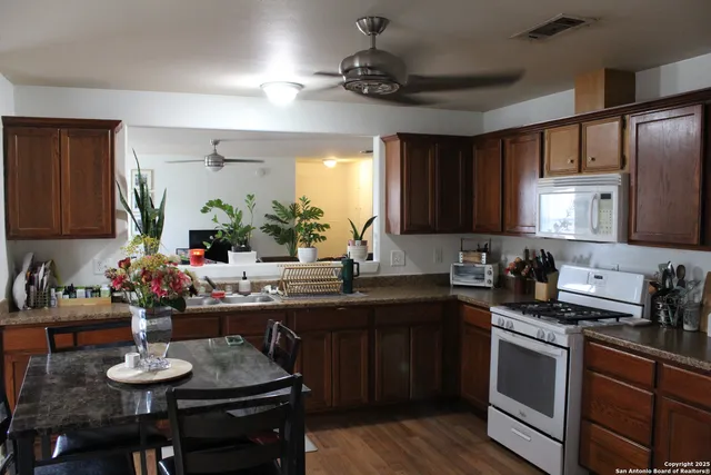 a kitchen with a sink stove and cabinets
