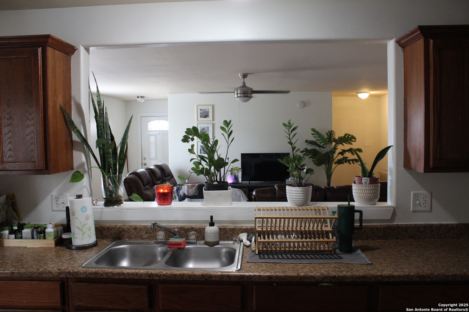 406 County Road 6850, Unit 1 Lytle, TX 78052 - Photo 8 of 24 a kitchen with a faucet a sink and a mirror