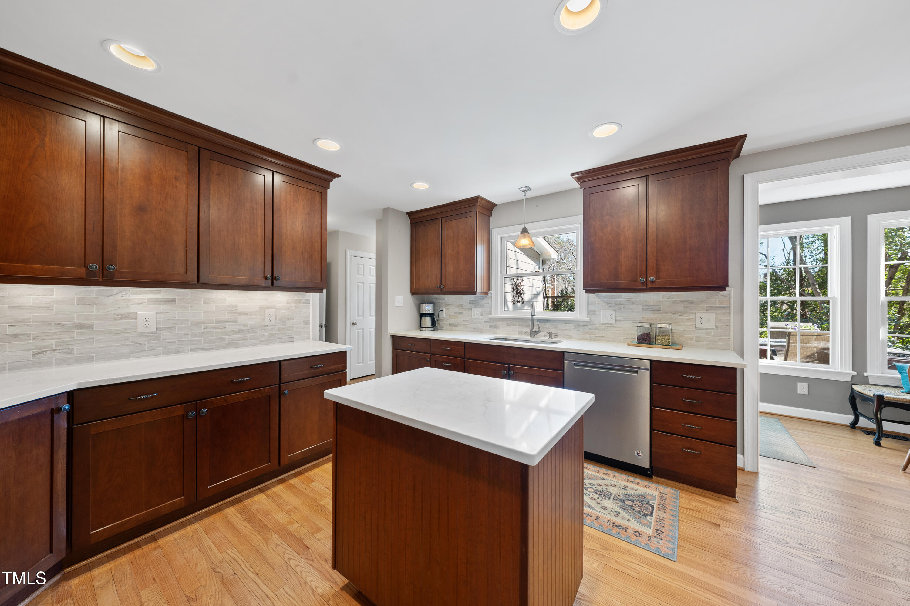 8616 Seagate Drive Raleigh, NC 27615 - Photo 11 of 56 a kitchen with a sink cabinets and wooden floor