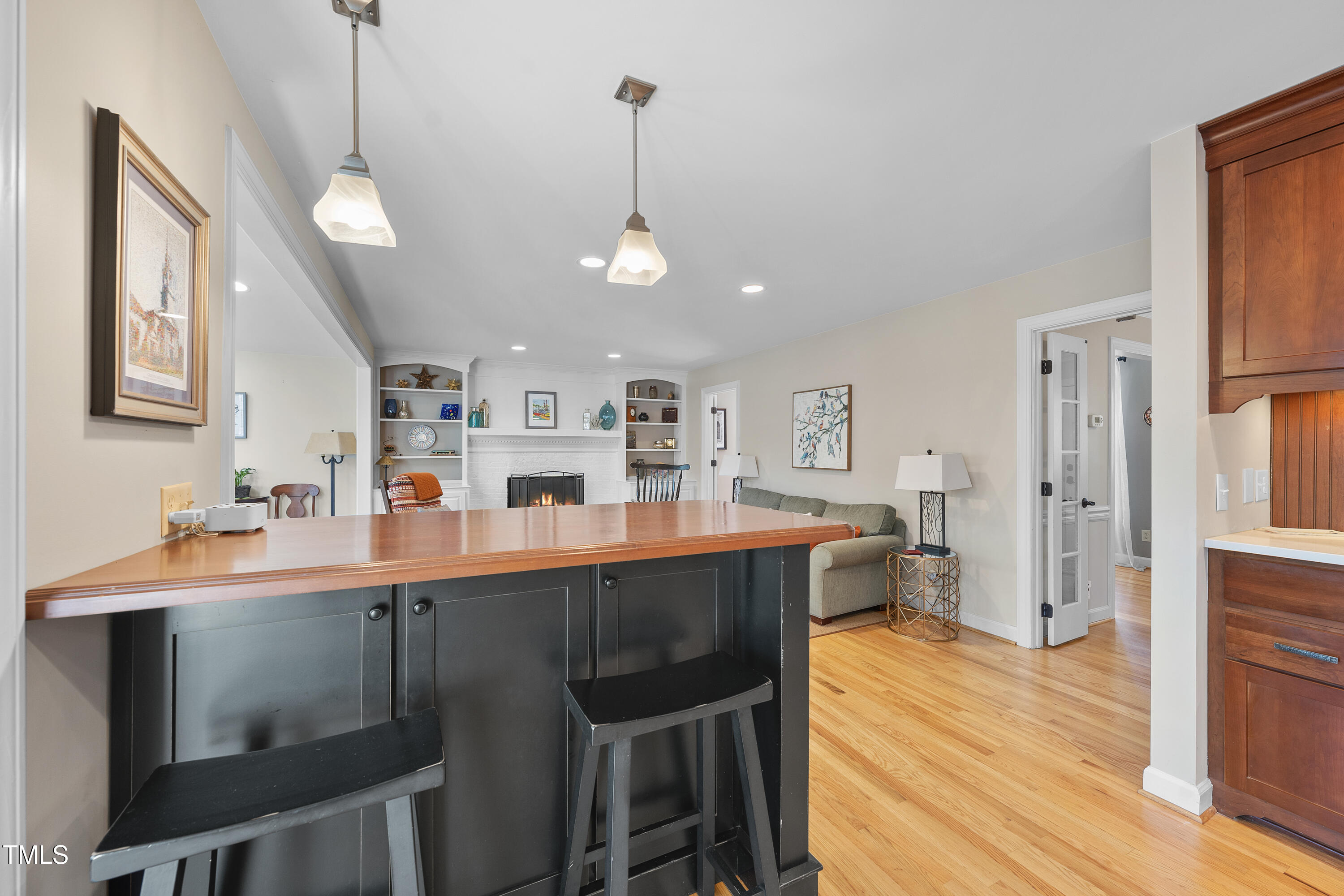 8616 Seagate Drive Raleigh, NC 27615 - Photo 15 of 56 a dining room with stainless steel appliances kitchen island granite countertop a table chairs and a refrigerator