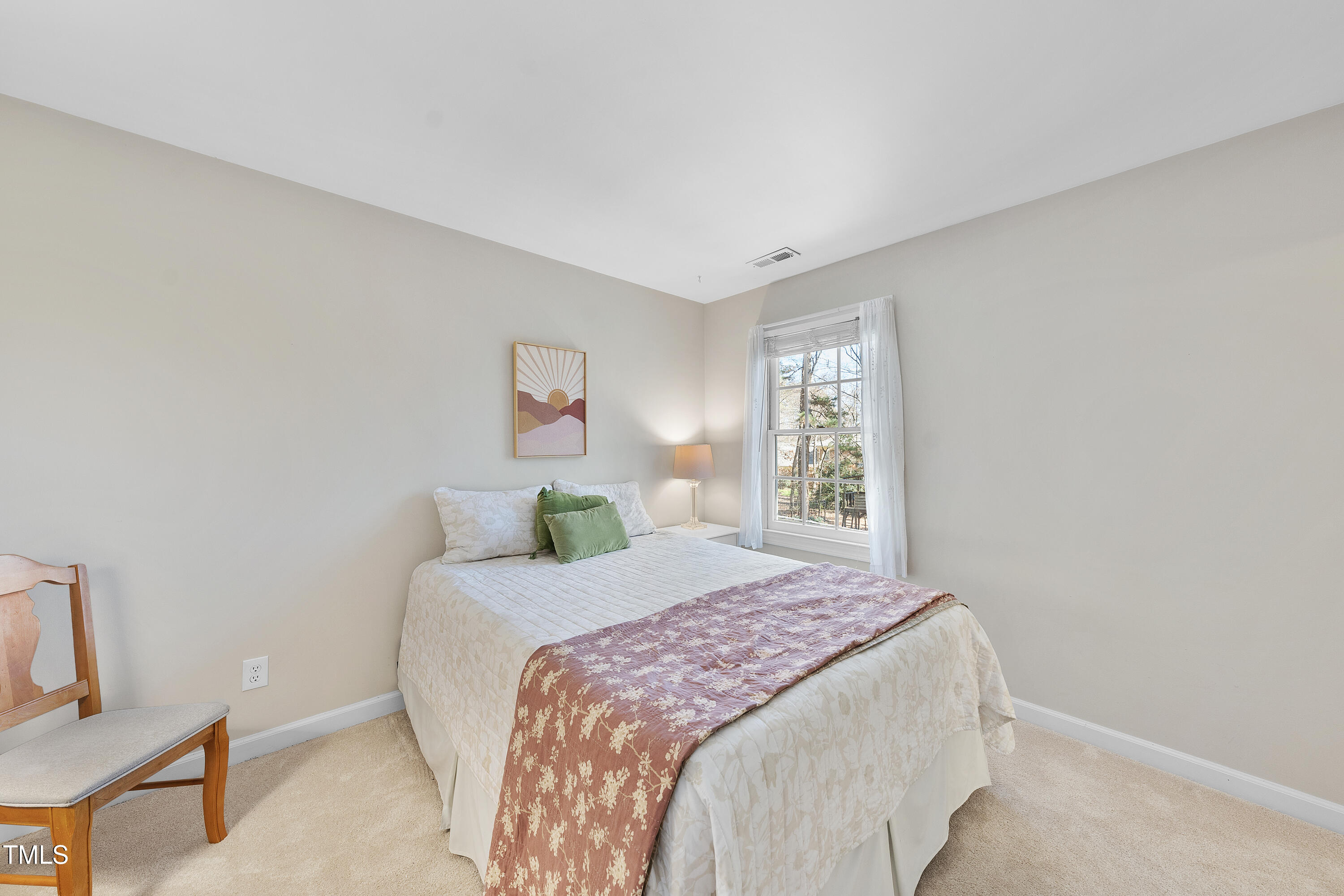 8616 Seagate Drive Raleigh, NC 27615 - Photo 38 of 56 a bedroom with a bed and a window