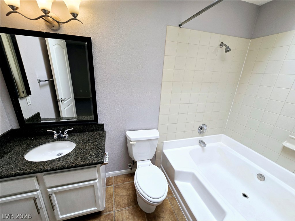 9325 West Desert Inn Road, Unit 229 Las Vegas, NV 89117 - Photo 7 of 17 Polished stone counters and clean tile surrounds accent this functional secondary bathroom.