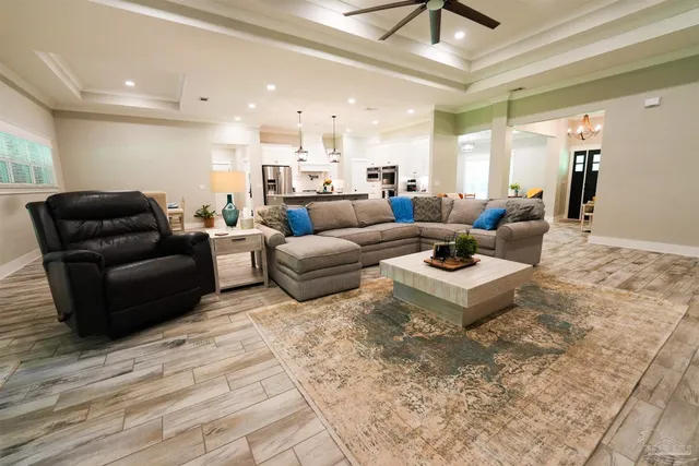 a large white kitchen with a large counter top appliances and cabinets