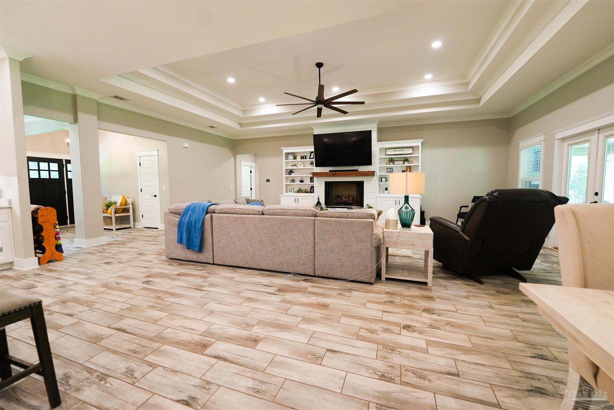 8410 Highway 97 Walnut Hill, FL 32568 - Photo 21 of 66 a living room with furniture a flat screen tv and kitchen view