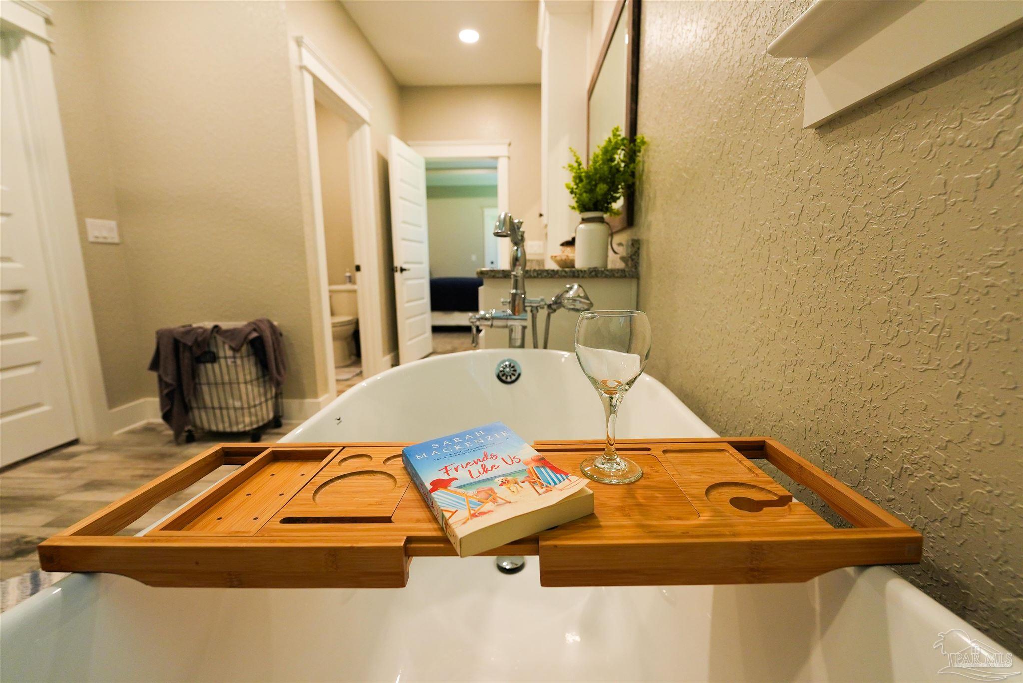 8410 Highway 97 Walnut Hill, FL 32568 - Photo 30 of 66 a bed sitting in a room next to a blue wall