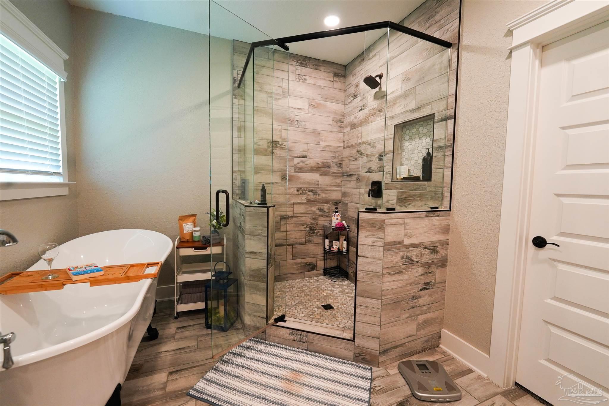 8410 Highway 97 Walnut Hill, FL 32568 - Photo 33 of 66 a bathroom with a bathtub and a shower