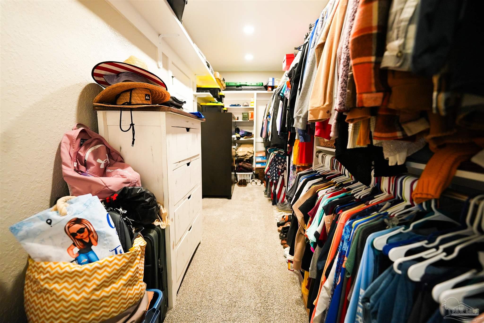 8410 Highway 97 Walnut Hill, FL 32568 - Photo 34 of 66 a view of walk in closet with clothes and shoes