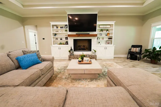 a living room with furniture a flat screen tv and a fireplace