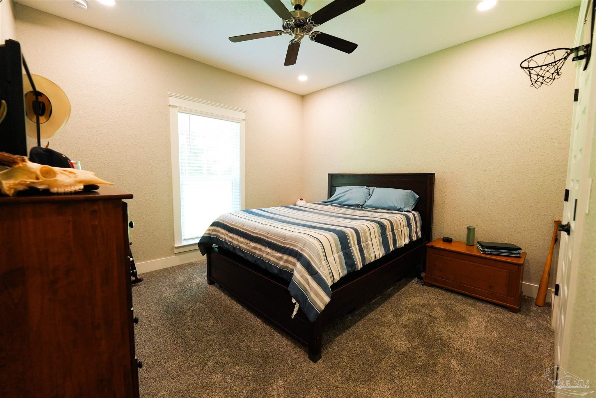 8410 Highway 97 Walnut Hill, FL 32568 - Photo 44 of 66 a bedroom with a bed and dresser with mirror