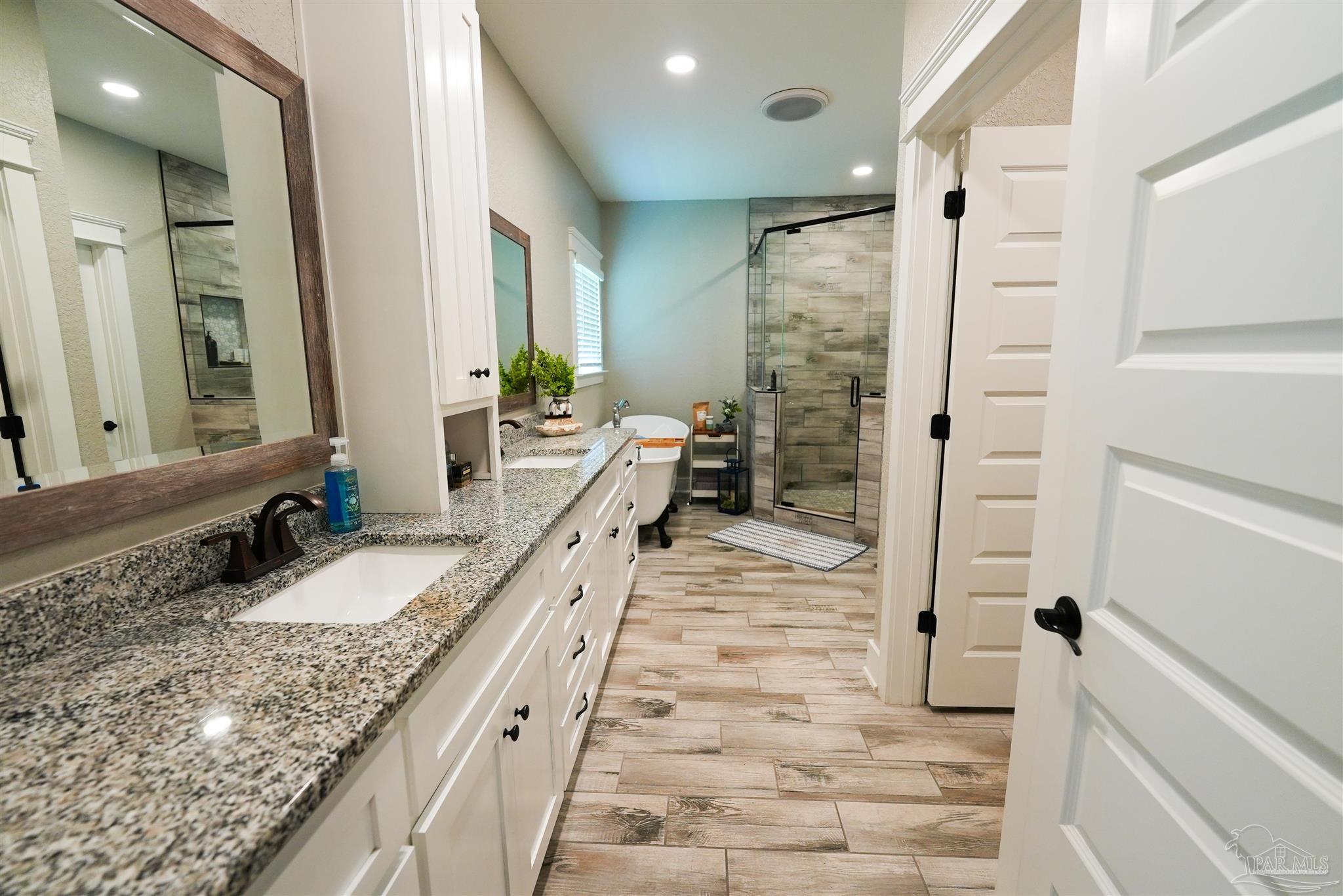 8410 Highway 97 Walnut Hill, FL 32568 - Photo 5 of 66 a bathroom with a granite countertop sink mirror and shower