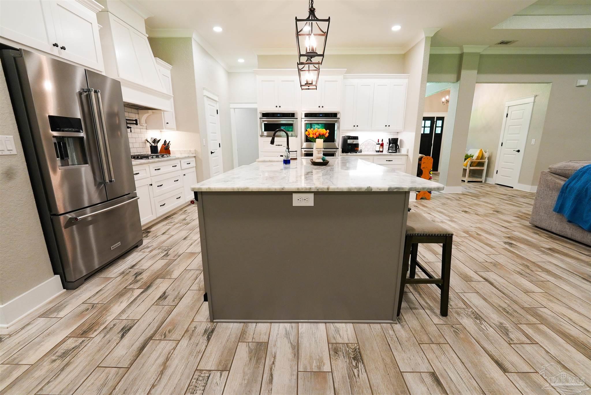 8410 Highway 97 Walnut Hill, FL 32568 - Photo 7 of 66 a kitchen with stainless steel appliances granite countertop a sink stove and refrigerator