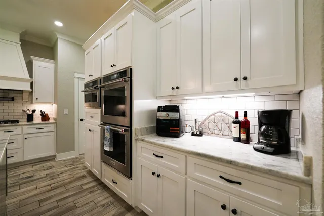 a kitchen with stainless steel appliances wooden cabinets and a stove top oven