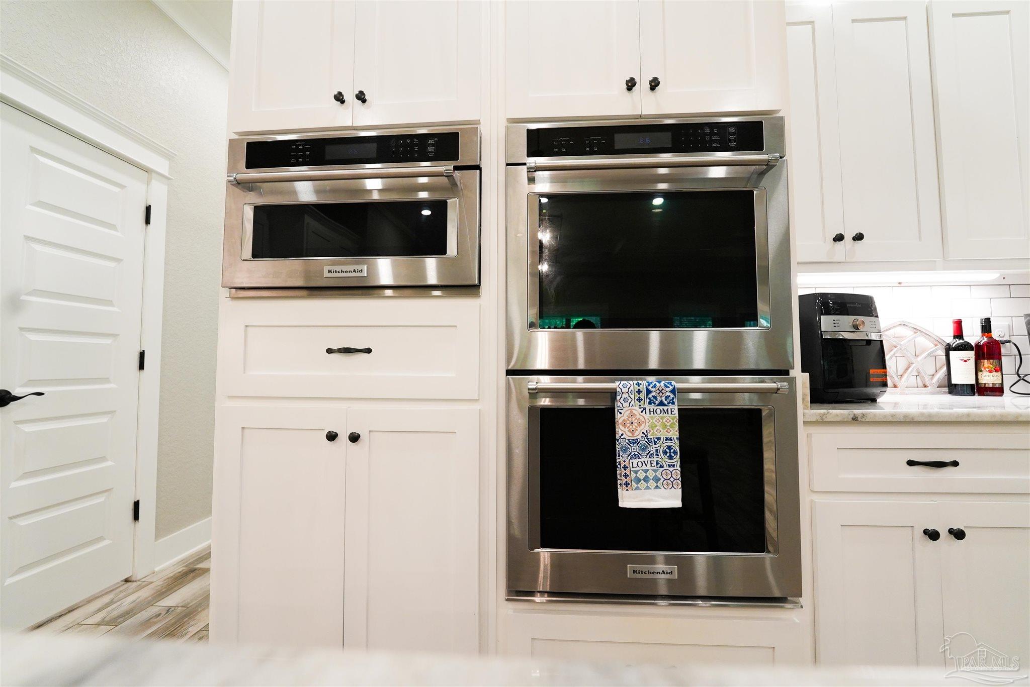 8410 Highway 97 Walnut Hill, FL 32568 - Photo 10 of 66 a kitchen with stainless steel appliances wooden cabinets and a stove top oven
