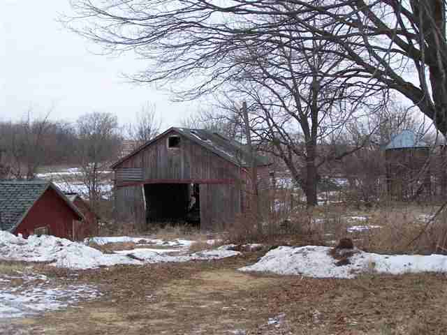 44042 Tower Road Freeport, IL 61032 - Photo 6 of 8 a front view of a house with a yard covered with snow