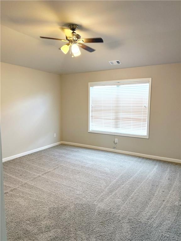 5296 Cheval Rue Court Suwanee, GA 30024 - Photo 34 of 51 an empty room with windows and fan