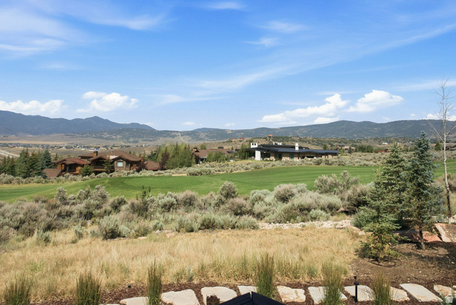 7885 North Rabbitbrush Court, Unit 13 Park City, UT 84098 - Photo 77 of 88 Expansive golf course and mountain scenery with natural landscaping and visible residential properties