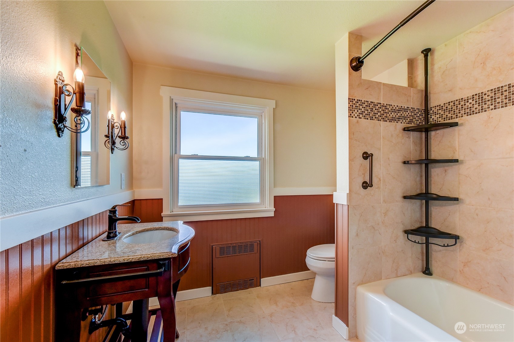 2824 Northwest 93rd Street Seattle, WA 98117 - Photo 18 of 38 a bathroom with a sink a toilet a mirror and shower