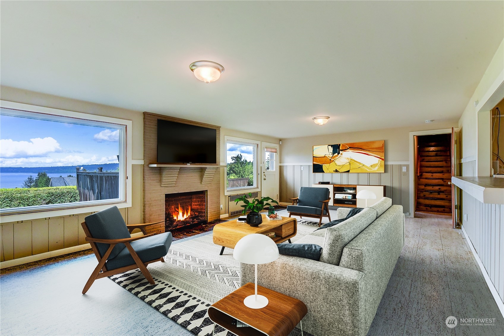 2824 Northwest 93rd Street Seattle, WA 98117 - Photo 22 of 38 a living room with furniture a fireplace and a flat screen tv