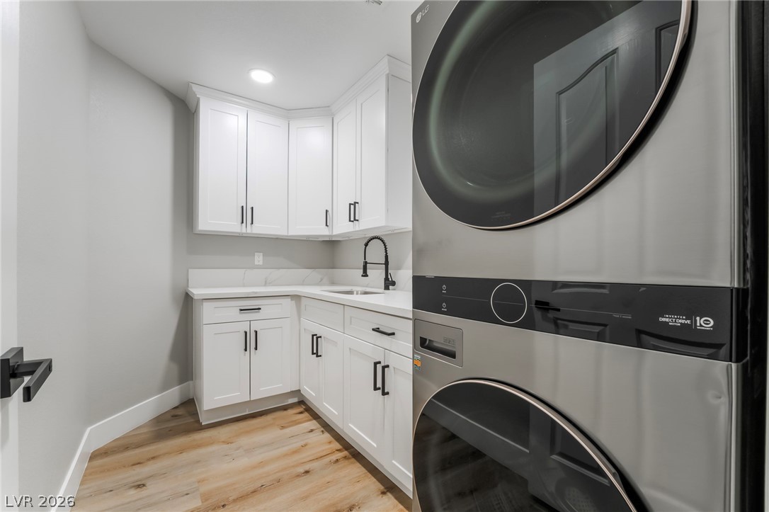 9171 West Viking Road Las Vegas, NV 89147 - Photo 23 of 43 A well-appointed laundry room features ample cabinetry and a convenient utility sink.
