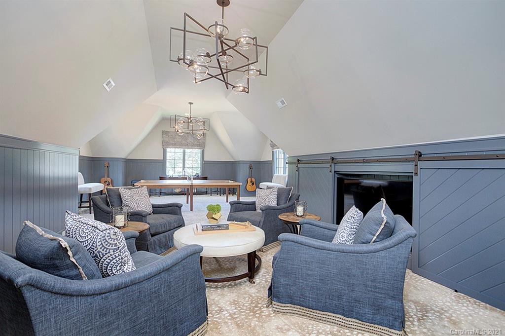 419 Bramble Way, Unit 7 Fort Mill, SC 29708 - Photo 17 of 40 a living room with couches a fireplace and a chandelier