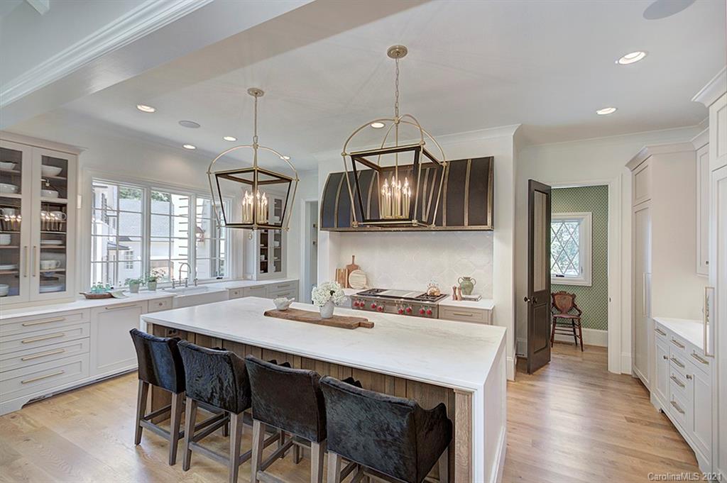 419 Bramble Way, Unit 7 Fort Mill, SC 29708 - Photo 3 of 40 a kitchen with stainless steel appliances a dining table chairs sink and cabinets
