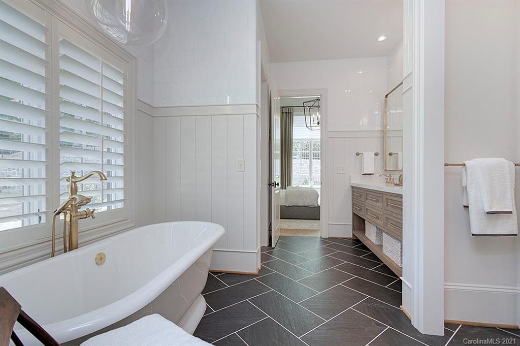419 Bramble Way, Unit 7 Fort Mill, SC 29708 - Photo 23 of 40 a bathroom with a tub a sink and a mirror