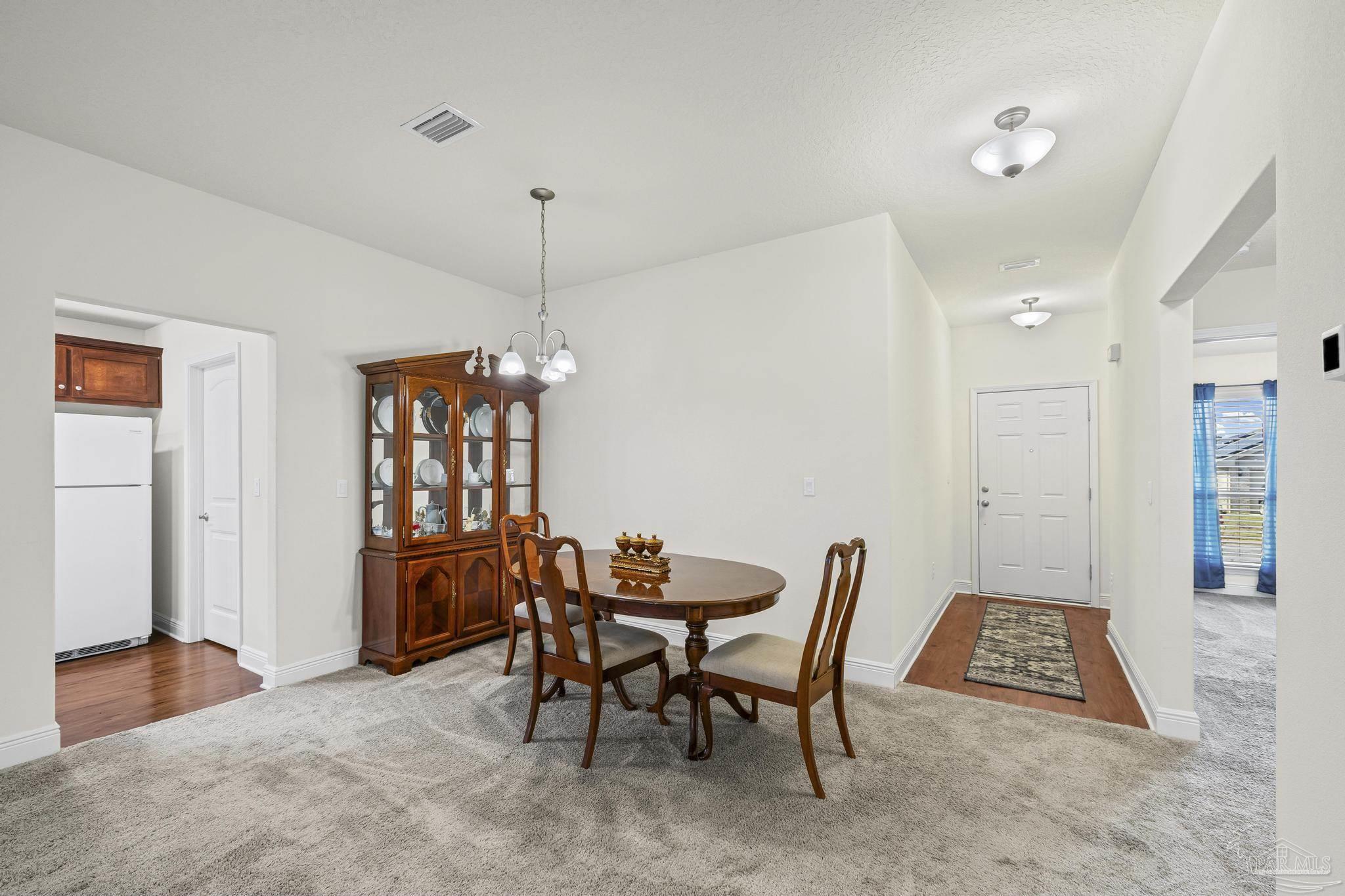 4442 Fiske Street Pace, FL 32571 - Photo 11 of 44 a view of a dining room with furniture and window