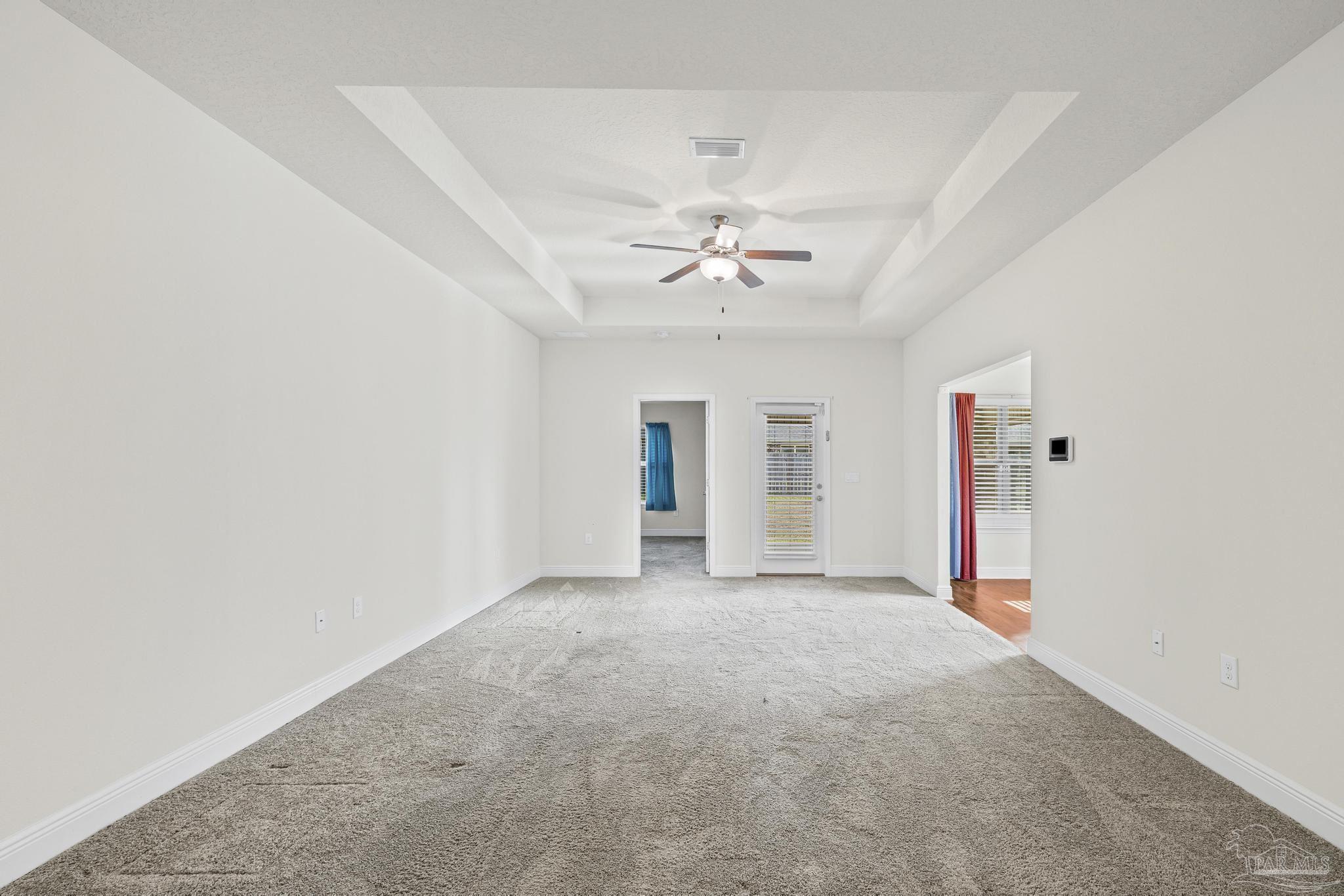 4442 Fiske Street Pace, FL 32571 - Photo 14 of 44 an empty room with an entryway and chandelier fan