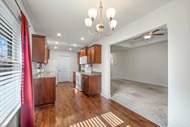 a view of a kitchen with a sink and wooden floor