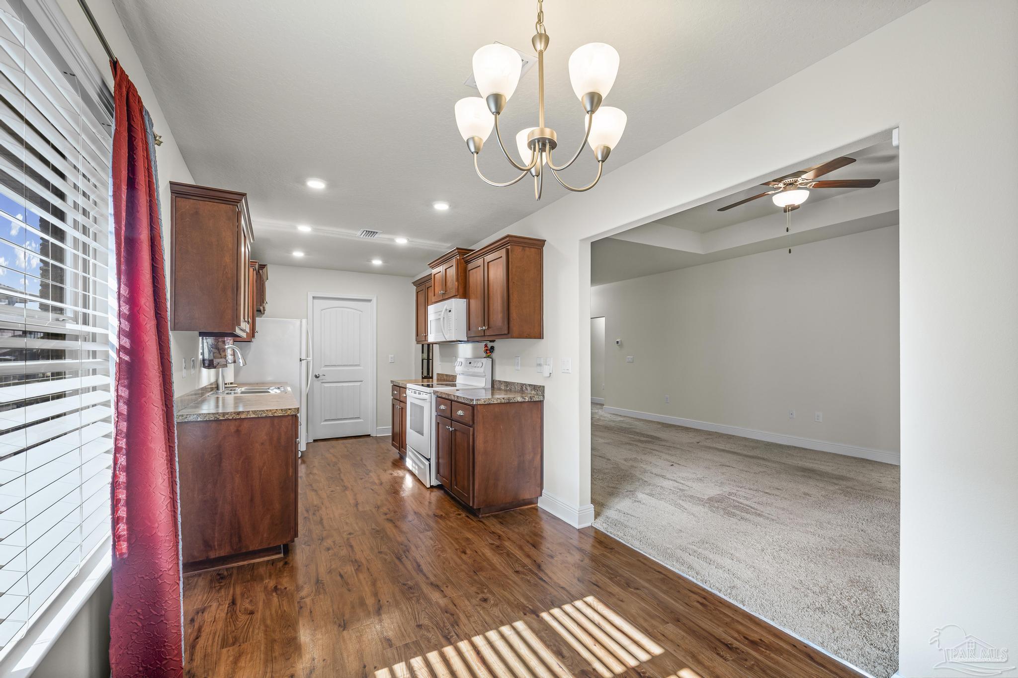 4442 Fiske Street Pace, FL 32571 - Photo 19 of 44 a view of a kitchen with a sink and wooden floor