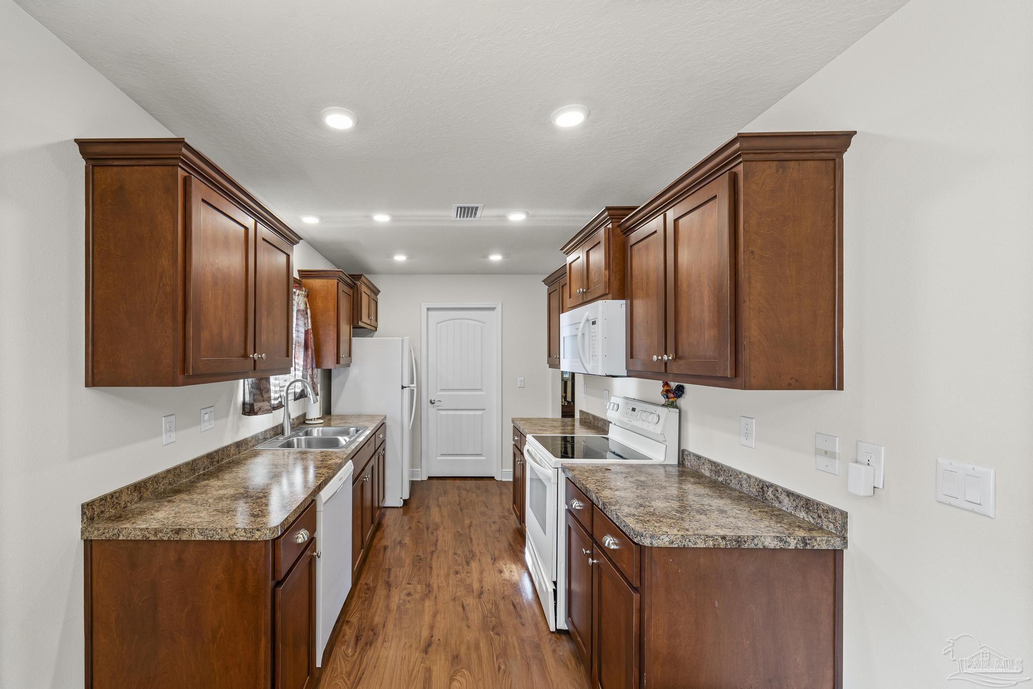 4442 Fiske Street Pace, FL 32571 - Photo 20 of 44 a kitchen with stainless steel appliances granite countertop a sink stove and refrigerator