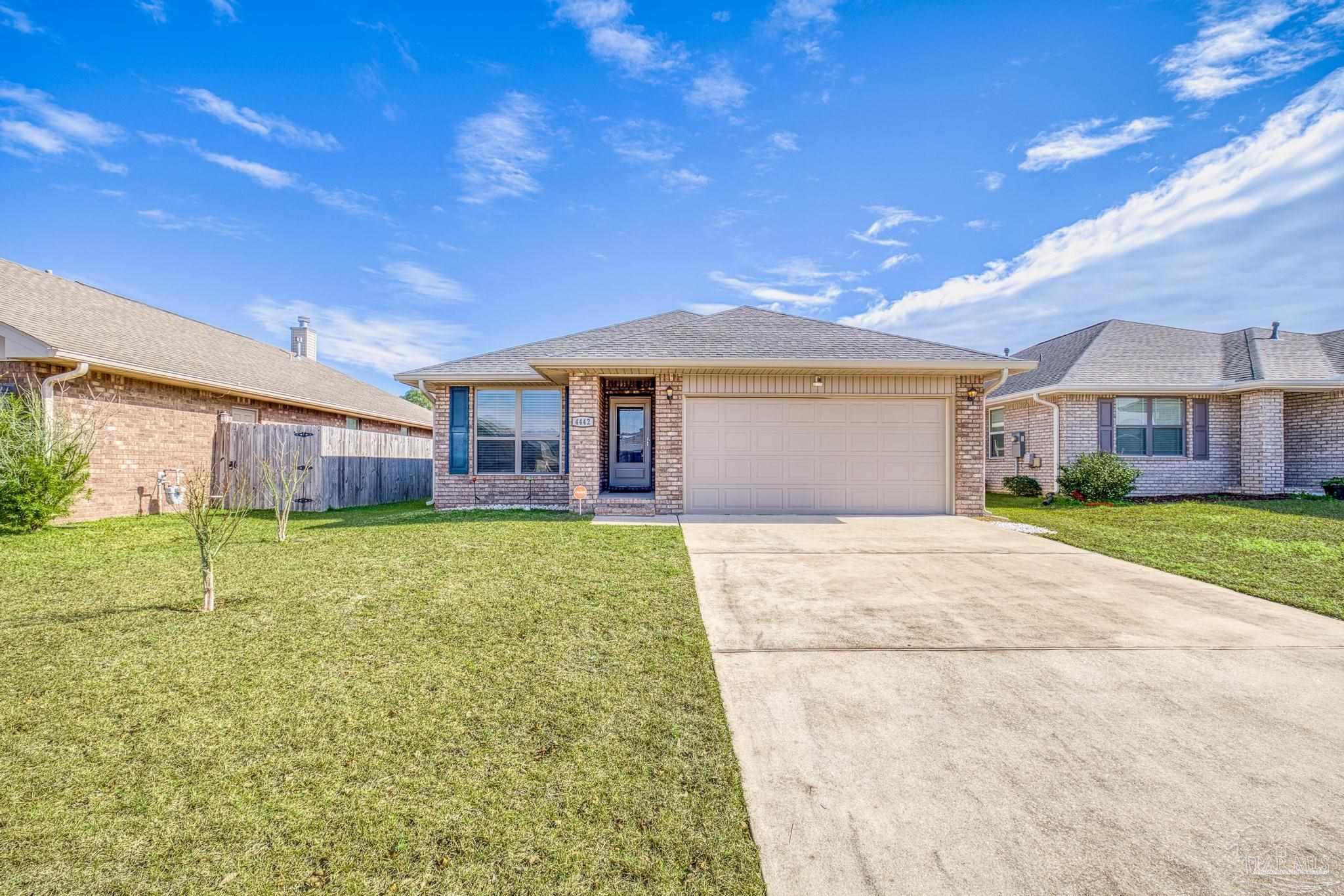 4442 Fiske Street Pace, FL 32571 - Photo 2 of 44 a view of an house with backyard and a tree