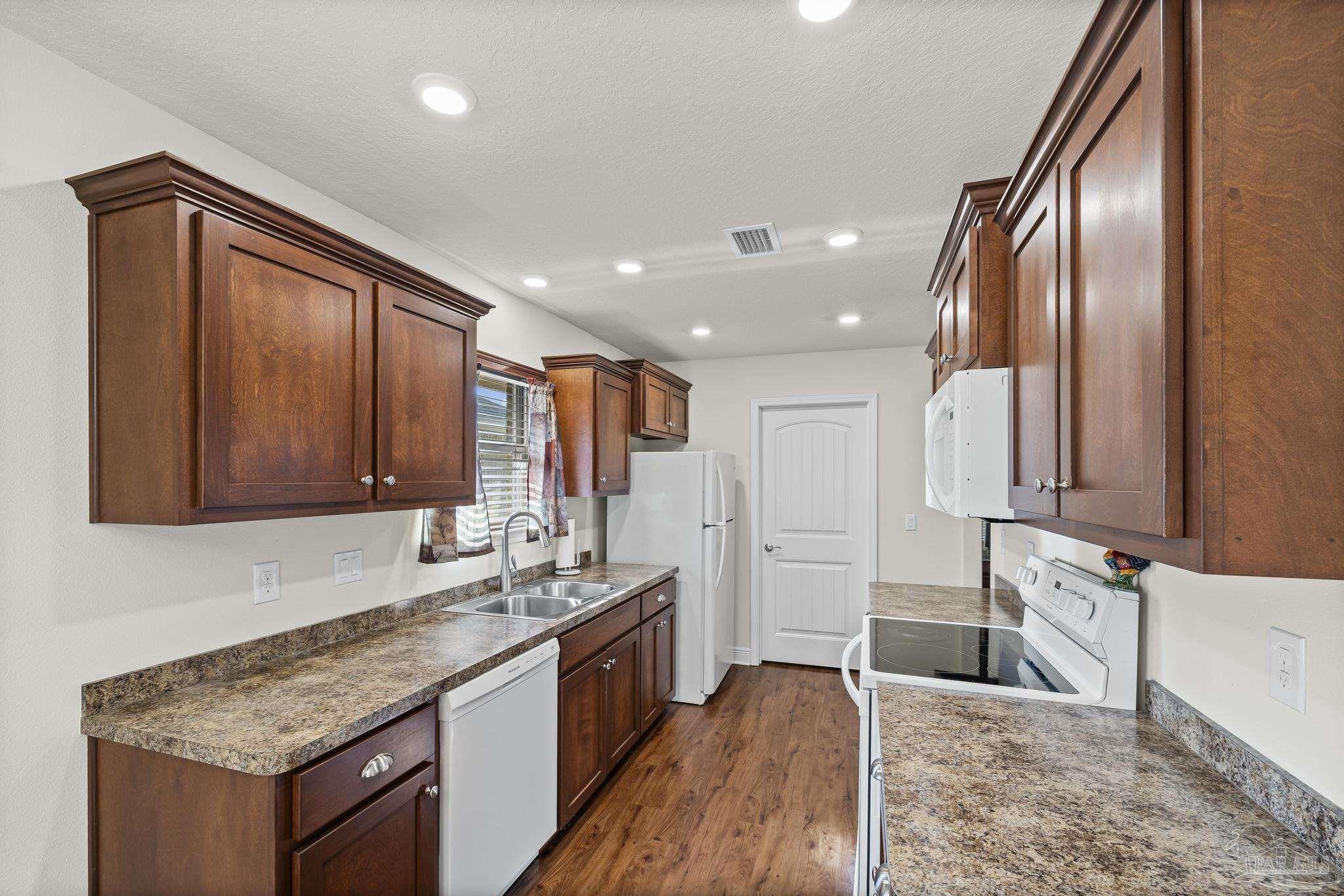 4442 Fiske Street Pace, FL 32571 - Photo 21 of 44 a kitchen with stainless steel appliances granite countertop a sink stove and cabinets