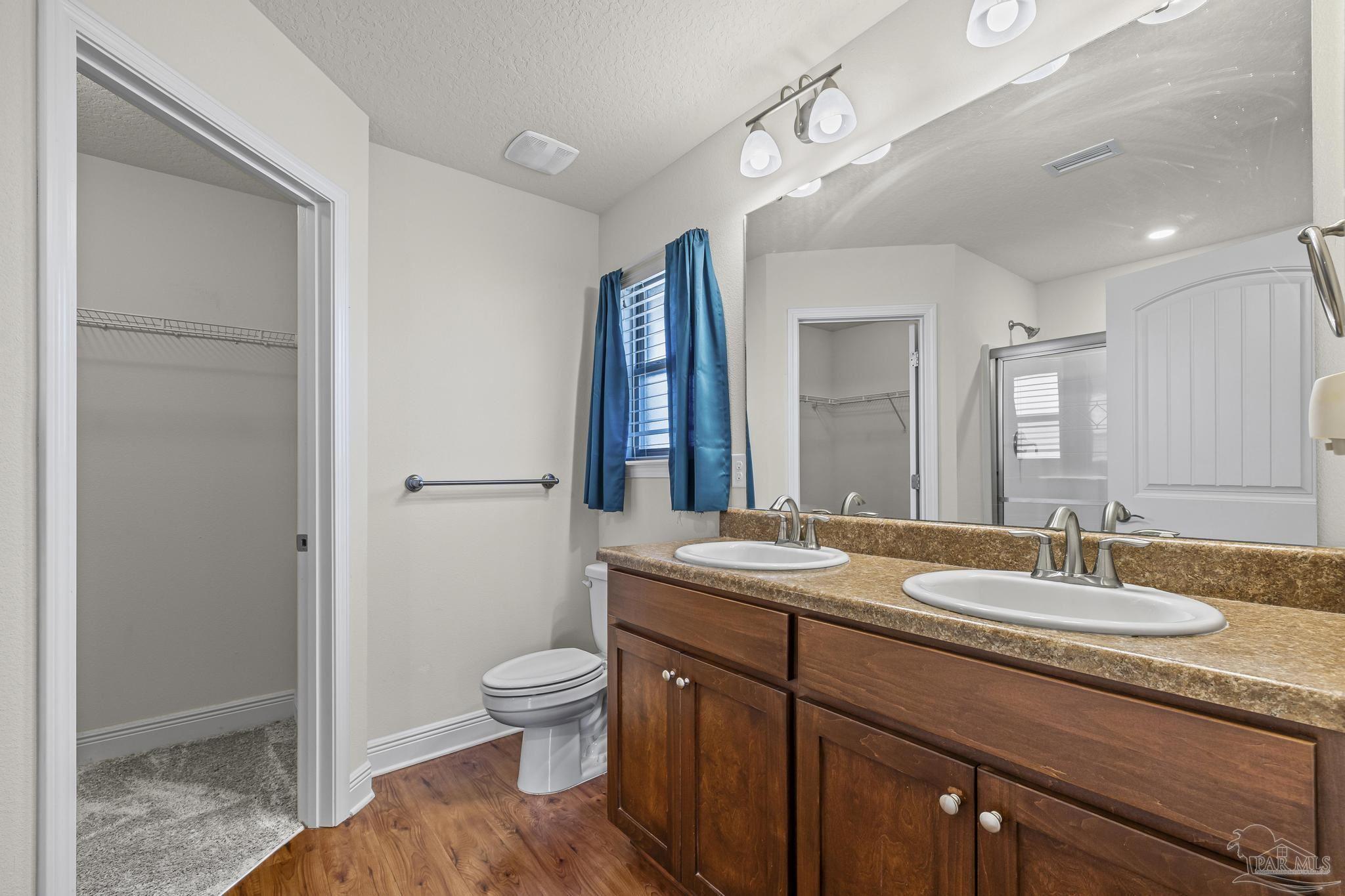 4442 Fiske Street Pace, FL 32571 - Photo 29 of 44 a spacious bathroom with a granite countertop sink a toilet and shower