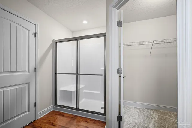 a view of water heater room with wooden floor
