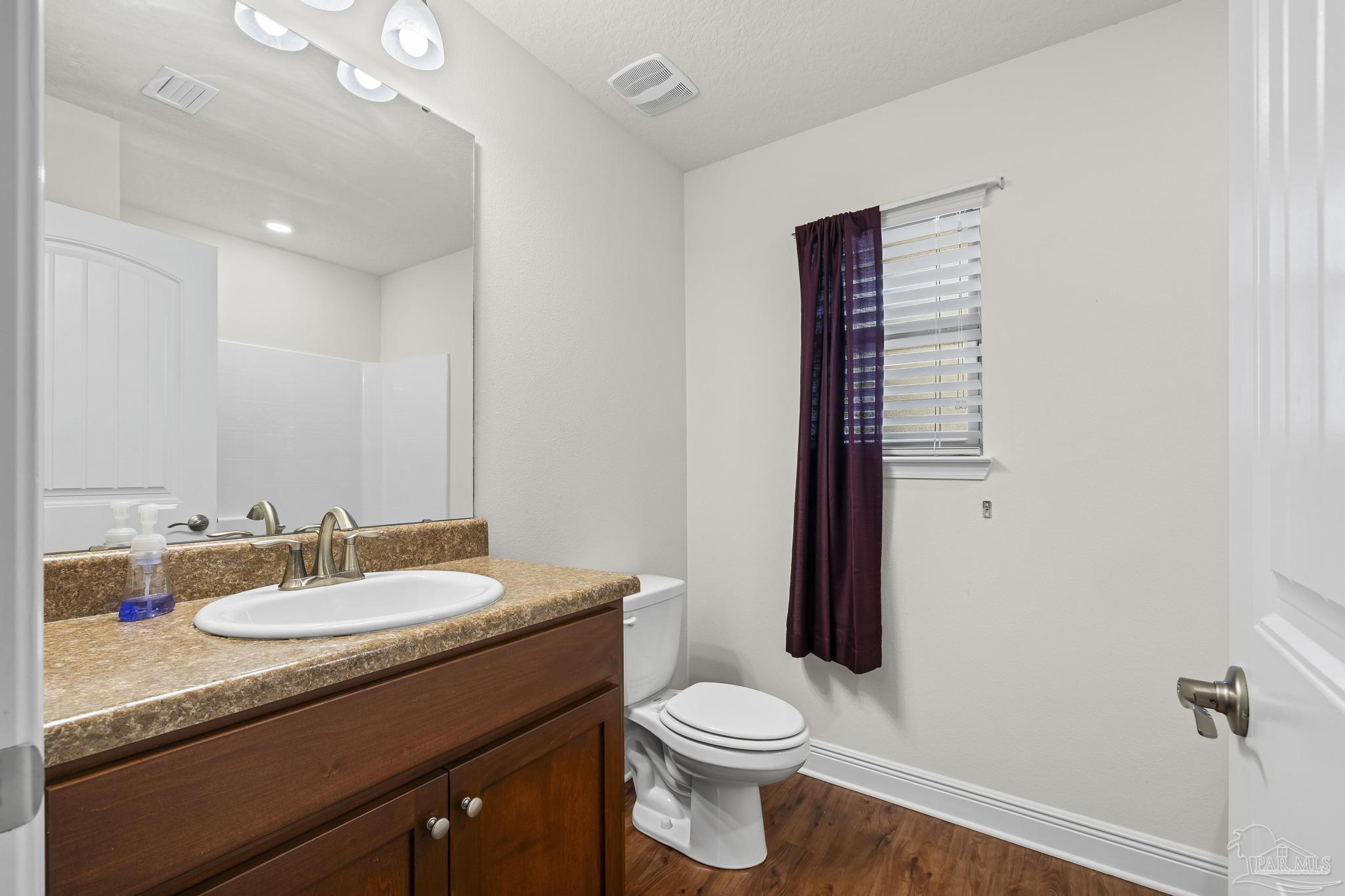 4442 Fiske Street Pace, FL 32571 - Photo 33 of 44 a bathroom with a sink a toilet and shower