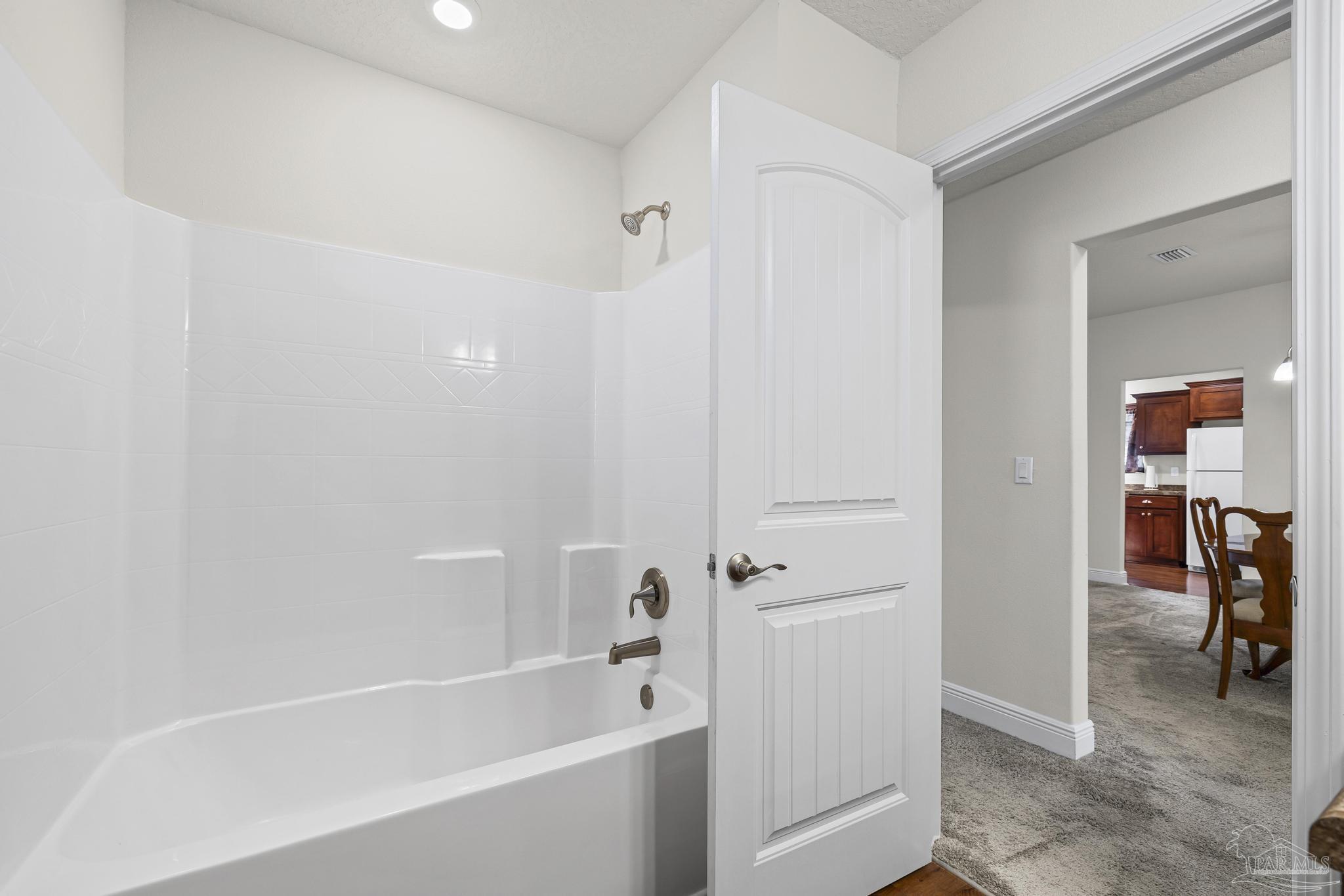 4442 Fiske Street Pace, FL 32571 - Photo 34 of 44 a white bath tub sitting next to a white sink