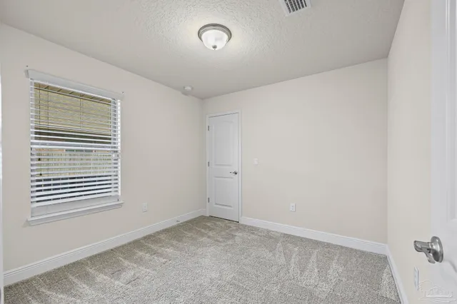 a view of empty room with windows