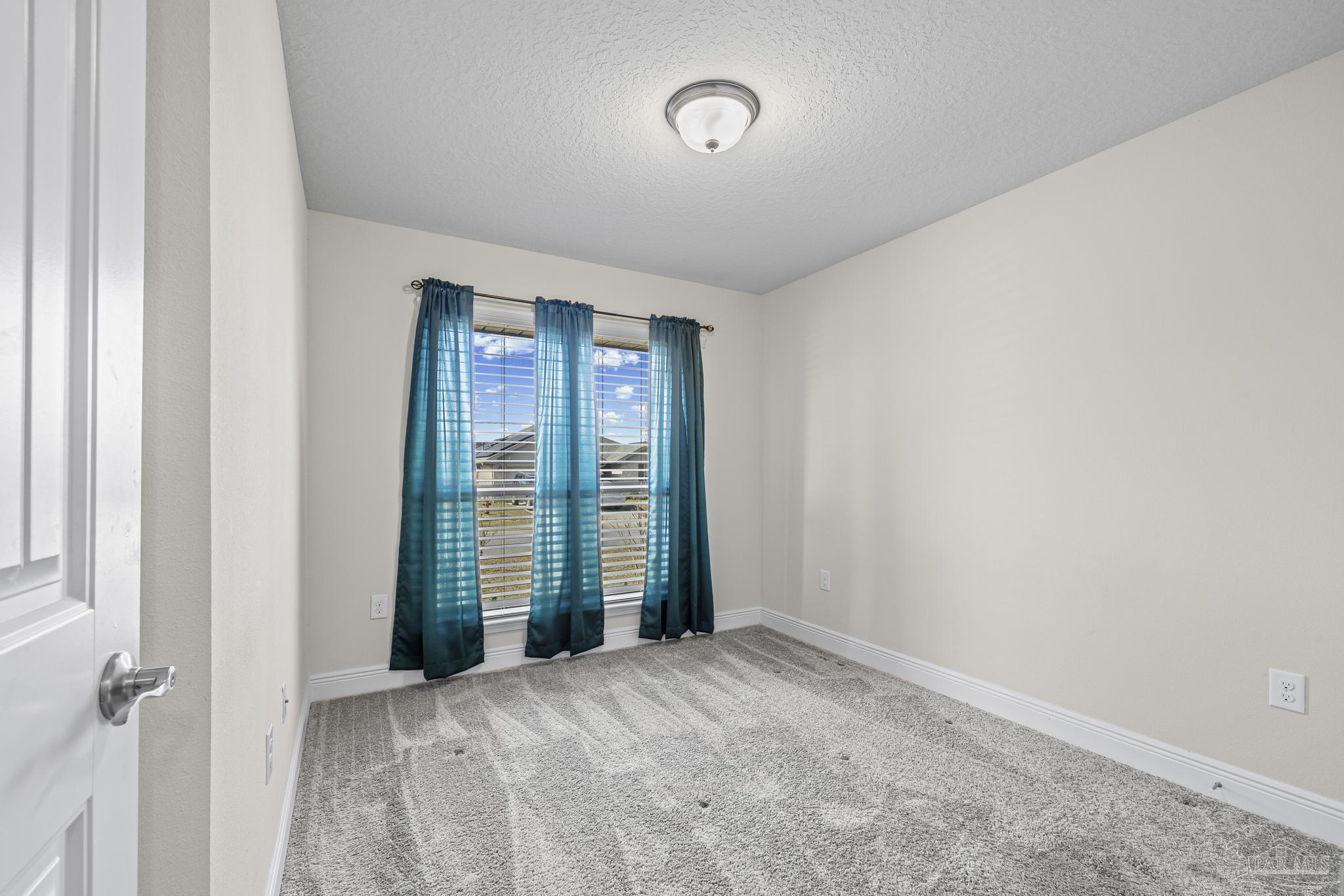 4442 Fiske Street Pace, FL 32571 - Photo 36 of 44 a view of an empty room with a window