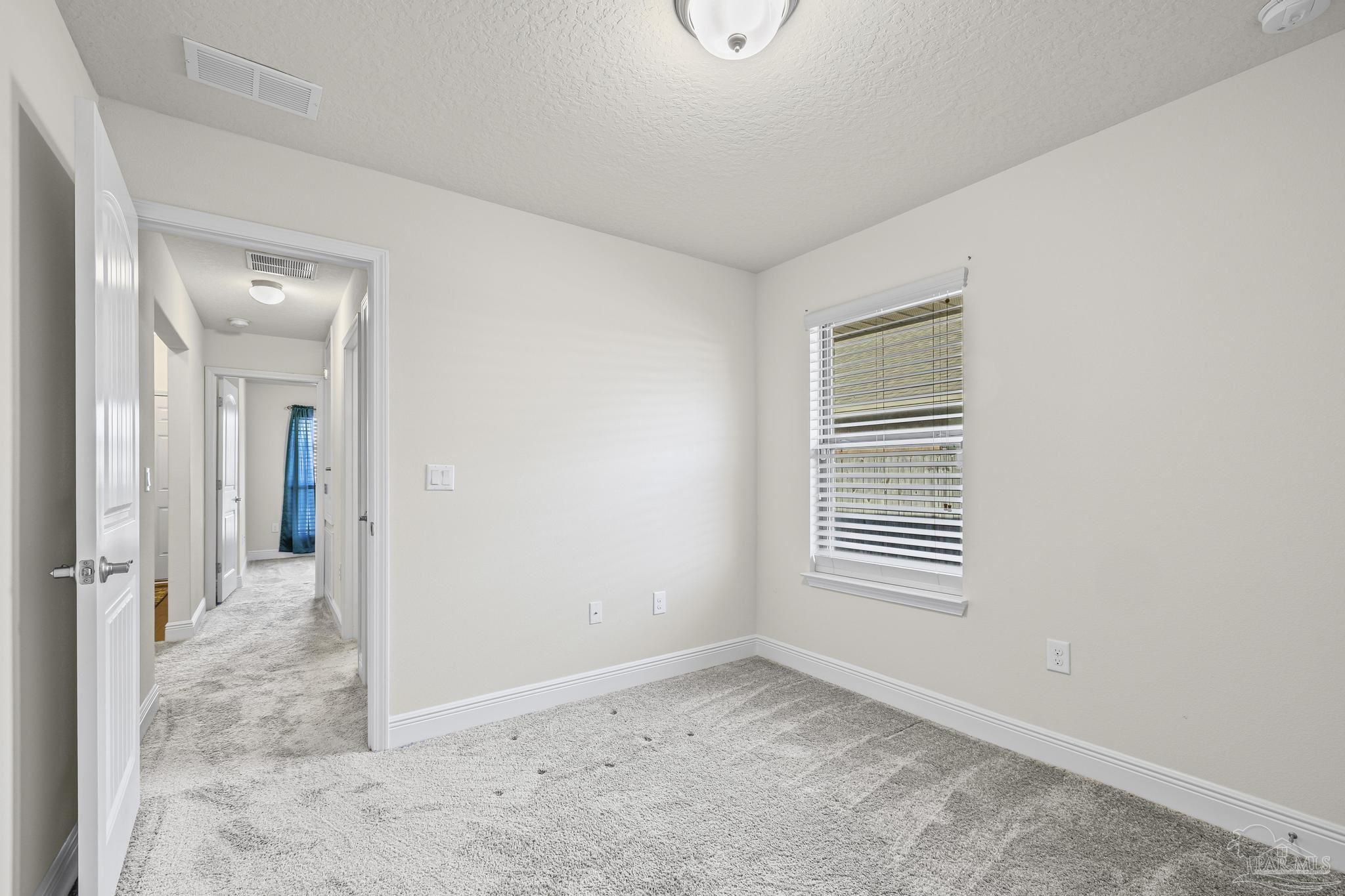 4442 Fiske Street Pace, FL 32571 - Photo 37 of 44 a view of an empty room with a window