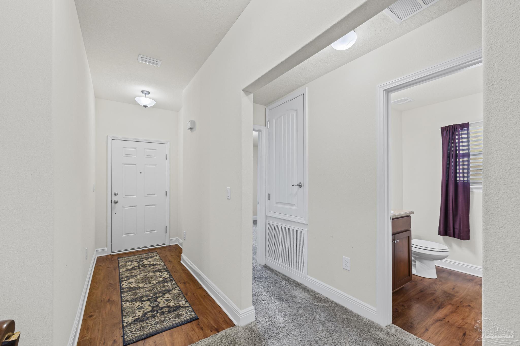 4442 Fiske Street Pace, FL 32571 - Photo 8 of 44 a view of room with wooden floor and bathroom