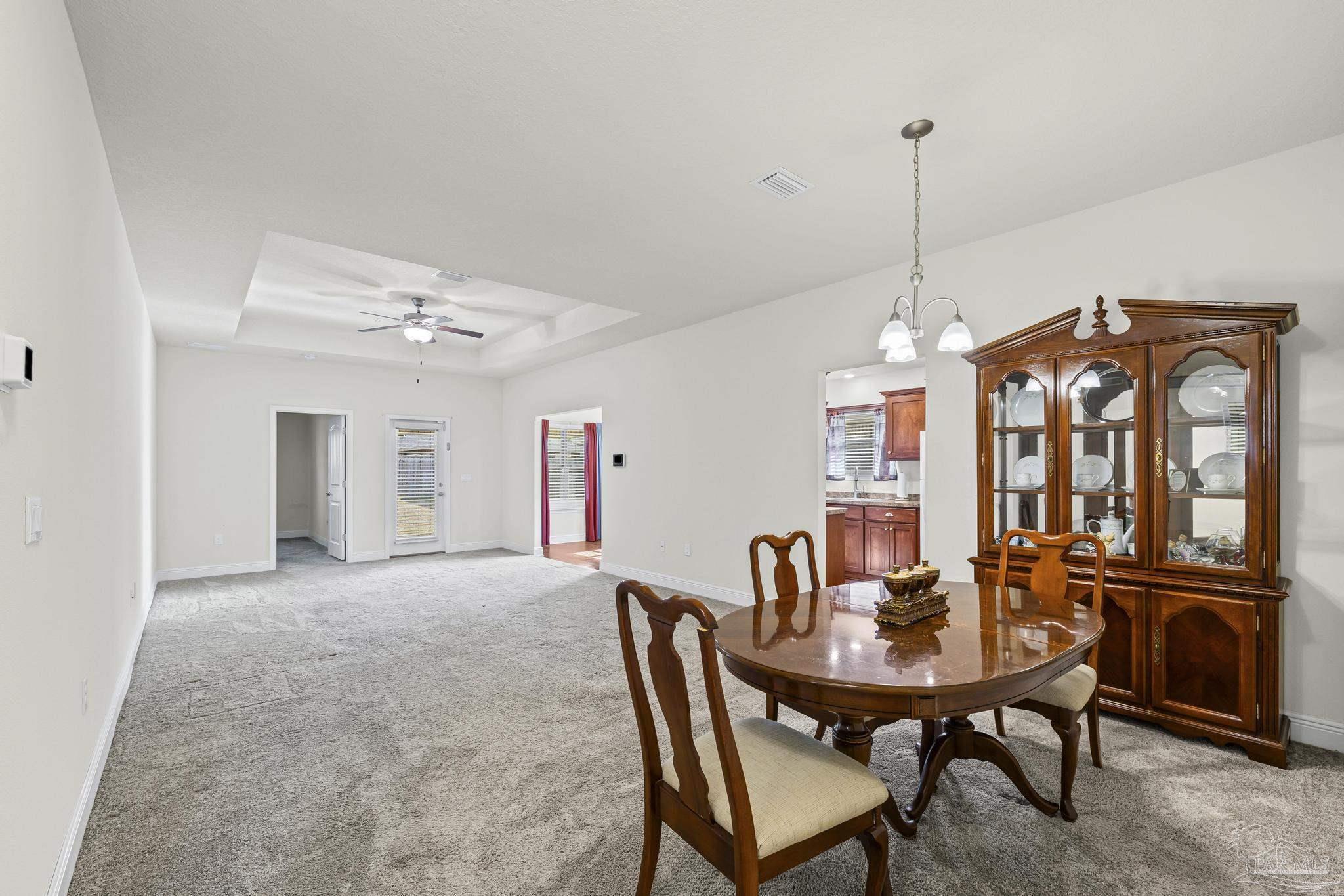 4442 Fiske Street Pace, FL 32571 - Photo 9 of 44 a view of a dining room with furniture