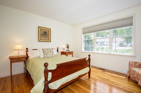 99 Stow Road, Unit 99 Boxborough, MA 01719 - Photo 13 of 27 a bedroom with a bed and wooden floor