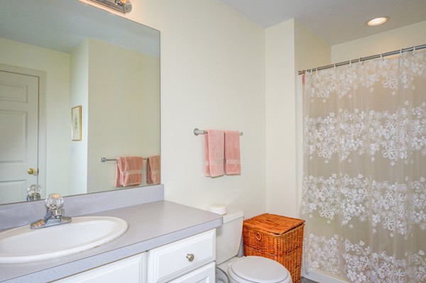 99 Stow Road, Unit 99 Boxborough, MA 01719 - Photo 15 of 27 a bathroom with a toilet a sink and a mirror