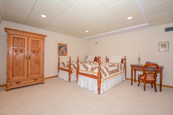 99 Stow Road, Unit 99 Boxborough, MA 01719 - Photo 20 of 27 a bedroom with furniture and a chandelier