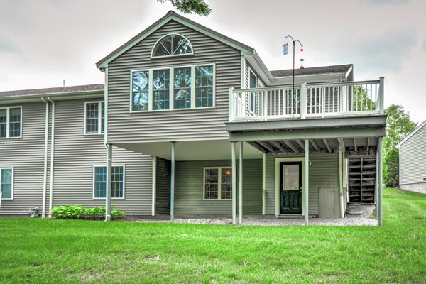 99 Stow Road, Unit 99 Boxborough, MA 01719 - Photo 21 of 27 a front view of a house with a yard