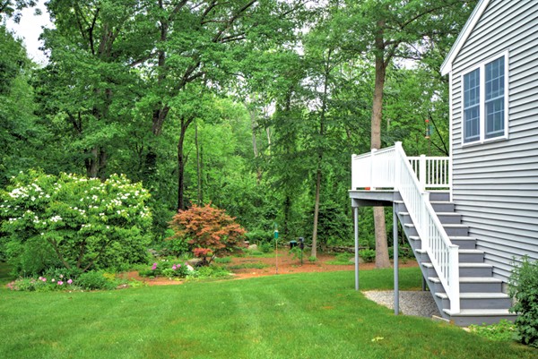 99 Stow Road, Unit 99 Boxborough, MA 01719 - Photo 22 of 27 a view of a house with a backyard