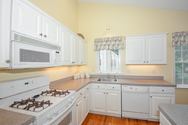 99 Stow Road, Unit 99 Boxborough, MA 01719 - Photo 3 of 27 a kitchen with a sink stove and cabinets