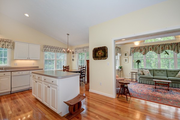 99 Stow Road, Unit 99 Boxborough, MA 01719 - Photo 5 of 27 a kitchen with a stove a refrigerator and a wooden floor