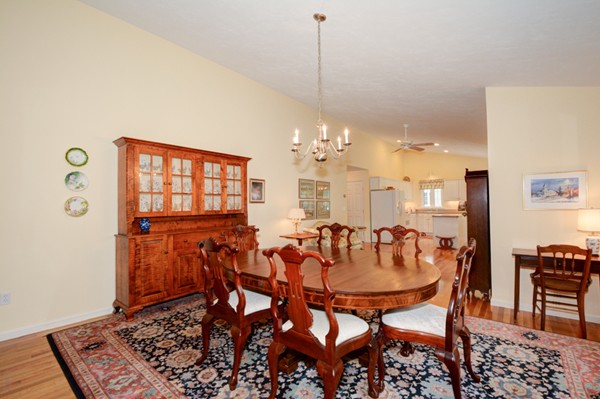 99 Stow Road, Unit 99 Boxborough, MA 01719 - Photo 8 of 27 a view of a dining room with furniture and chandelier